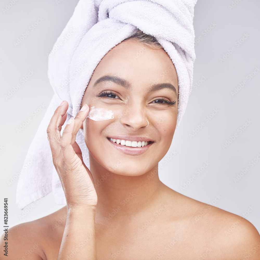 Happy woman, portrait and skincare with cream for moisturizing or ointment on a gray studio background. Face of female person or model with smile for lotion, anti aging or healthy skin and hygiene Happy woman, portrait and skincare with cream for moisturizing or ointment on a gray studio background. Face of female person or model with smile for lotion, anti aging or healthy skin and hygiene