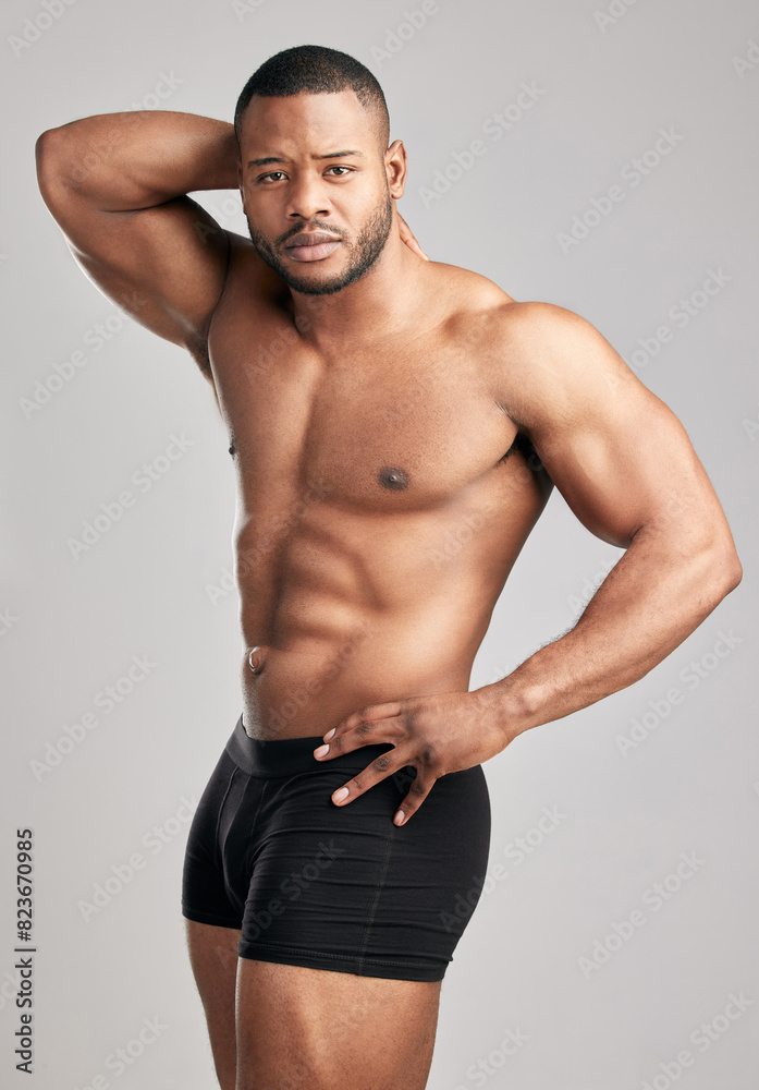 Muscle, portrait and black man in studio with underwear for fitness or health with confidence for flexing. Wellness, strength and bodybuilding competition in America with pride for body with training