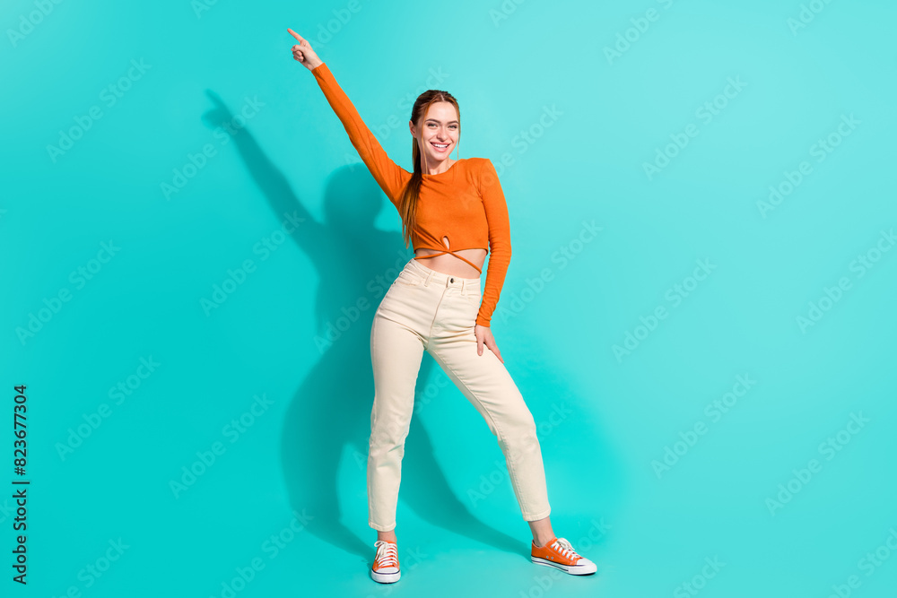 Full length photo of positive adorable woman wear crop top white trousers raising finger up isolated on turquoise color background