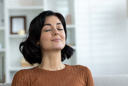 Woman with closed eyes practicing mindfulness and relaxation at home Free Download Woman with closed eyes practicing mindfulness and relaxation at home - GFXLoad