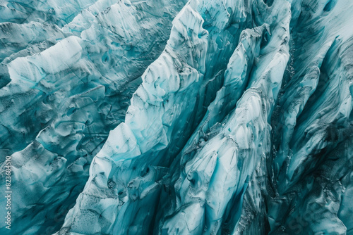 Wallpaper Mural Aerial view of a glacier, capturing the intricate patterns and textures formed by the ice. Highlight the natural lines and subtle color variations to create a minimalist, abstract composition. Torontodigital.ca