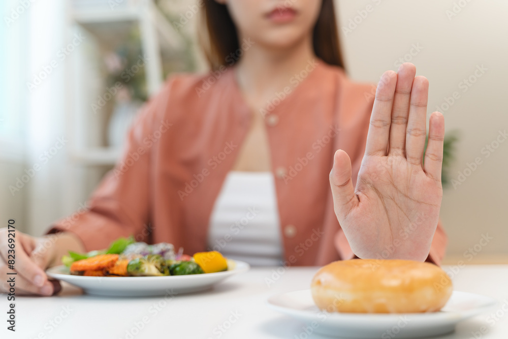 Diet food loss weight concept, Hand of woman pushing sweet away and avoid to eat fried chicken to control cholesterol and sugar.