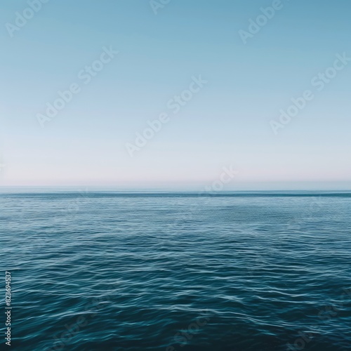The ocean is calm and peaceful, with a clear blue sky above © PuiZera