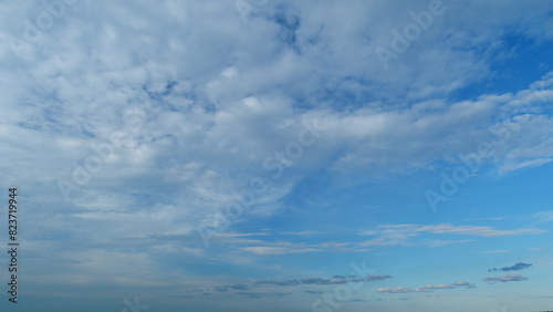 Amazing white fluffy clouds moving softly on bright blue sky. Change of weather. Timelapse.