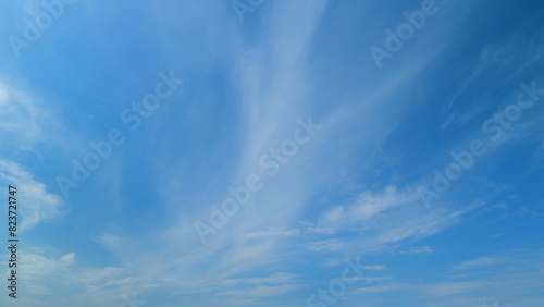 Tropical summer sunlight. Blue sky with cirrus clouds. Fluffy layered clouds sky atmosphere. Timelapse. photo