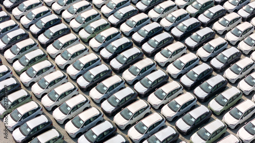 Aerial top view rows of new cars parked in distribution center on car factory, Automobile and automotive car parking lot for commercial business industry to dealership for sale at port terminal
