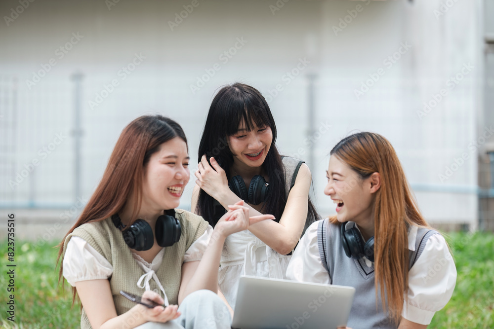 Group of young university students laughing and studying on campus lawn. Friends enjoying outdoor learning and bonding. Concept of education, friendship, and student life Group of young university students laughing and studying on campus lawn. Friends enjoying outdoor learning and bonding. Concept of education, friendship, and student life