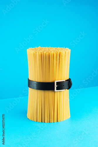 Huge pile of spaghetti tied up with a belt