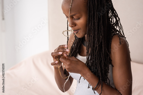 African woman doing hair routine at home photo