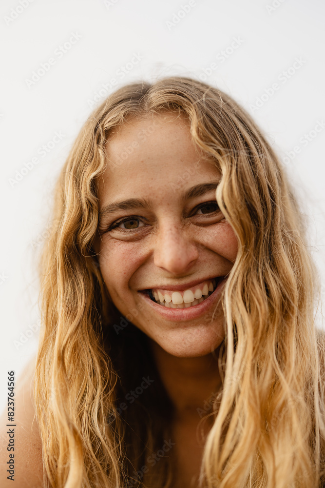 portrait of a woman with natural wavy blonde hair laughing portrait of a woman with natural wavy blonde hair laughing