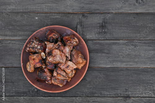 pork ribs cooked on the grill are in a plate. copy space