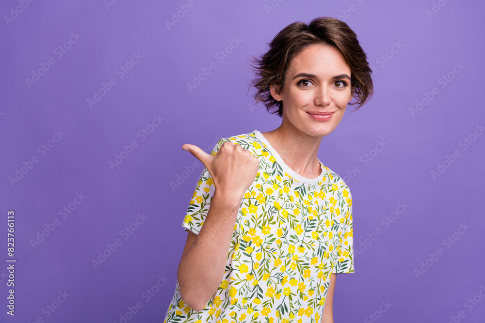 Photo of lovely satisfied cute girl wear trendy clothes recommend offer empty space poster isolated on purple color background Photo of lovely satisfied cute girl wear trendy clothes recommend offer empty space poster isolated on purple color background