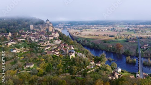 Aerial shot with mist over the chateau of Castelnaud la chapelle in the Dordogne. photo