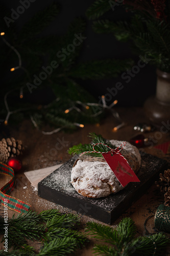 Christmas stollen cake on a wooden box on a rustic background. Traditional handmade German Christmas dessert. Fruit bread Stollen with nuts  raisins and marzipan.