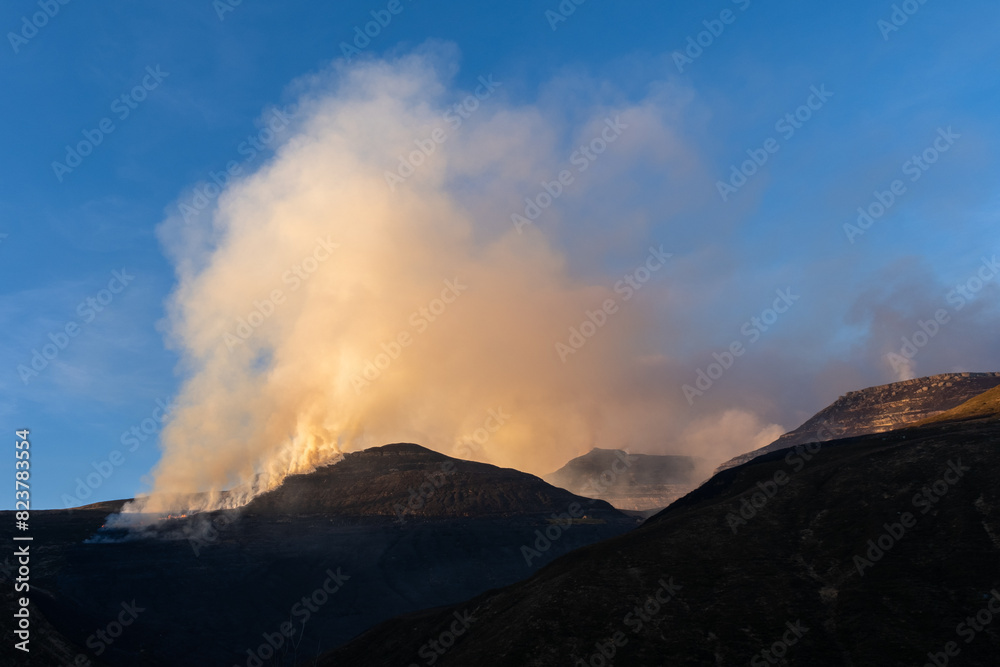 Smoke of a wildfire at the top of the mountain Smoke of a wildfire at the top of the mountain