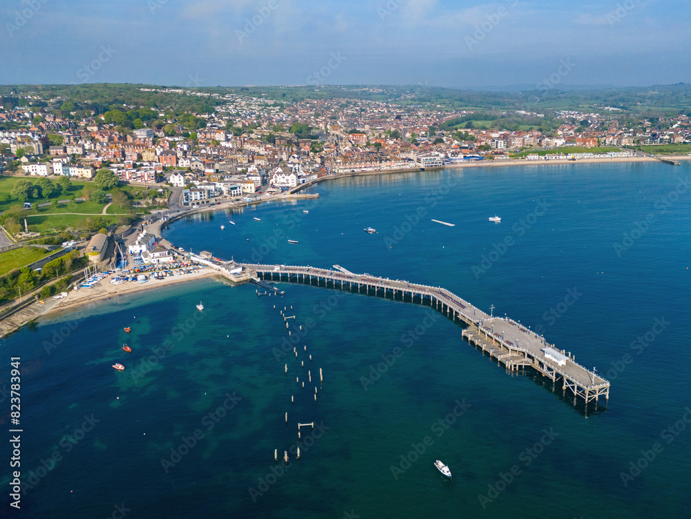 Fototapeta premium Swanage, Dorset. United Kingdom. Spring time Aerial image of one of Southern Englands finest coastal Towns. 9th May 2024