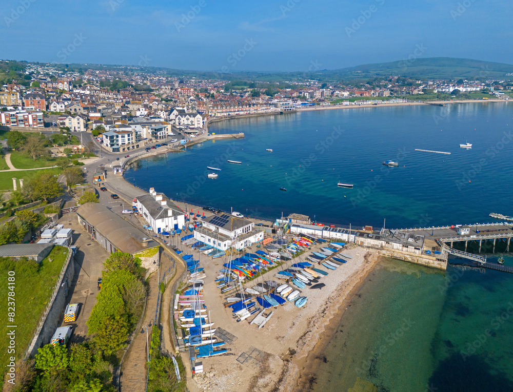 Fototapeta premium Swanage, Dorset. United Kingdom. Spring time Aerial image of one of Southern Englands finest coastal Towns. 9th May 2024