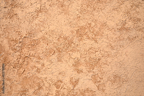 Textured background of brown and beige plaster