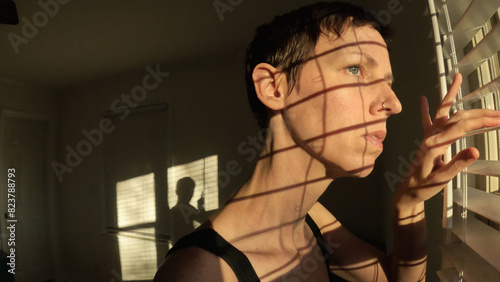 Woman Looking Out Bedroom Window Morning Light