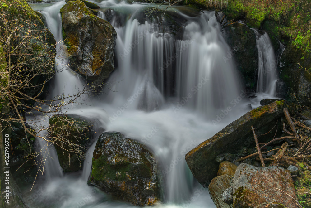 Fototapeta premium Spring creek under Simplonpass with waterfall in sunny day