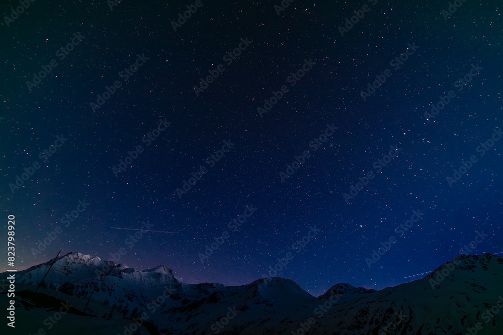 Night blue sky in spring evening with snow and star lights