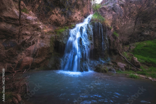 Beautiful Karaungir waterfall next to the cave of an ancient man in the Turkestan region of Kazakhstan