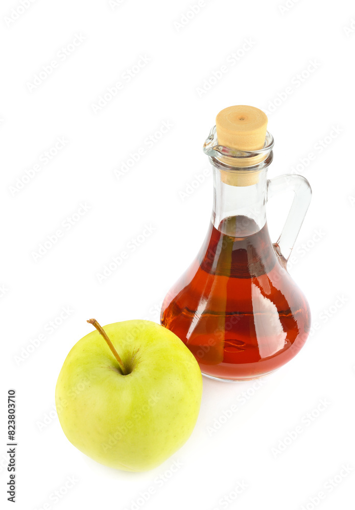 Apple vinegar in a bottle and fresh apples isolated on a white. Vertical photo Apple vinegar in a bottle and fresh apples isolated on a white. Vertical photo