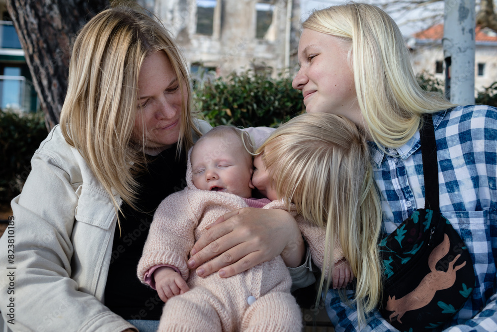 Woman and her three daughters outdoors Woman and her three daughters outdoors