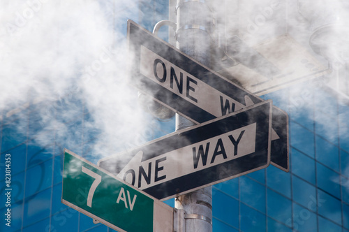 Traffic signs for one way street in the white haze photo