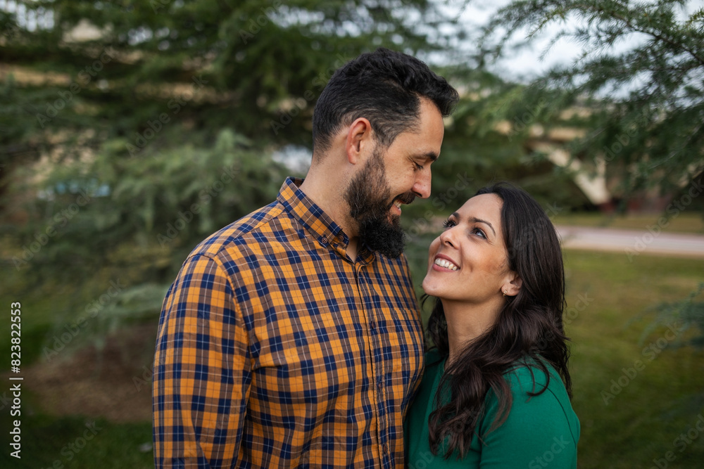 portrait of young couple hugging outdoors in nature portrait of young couple hugging outdoors in nature