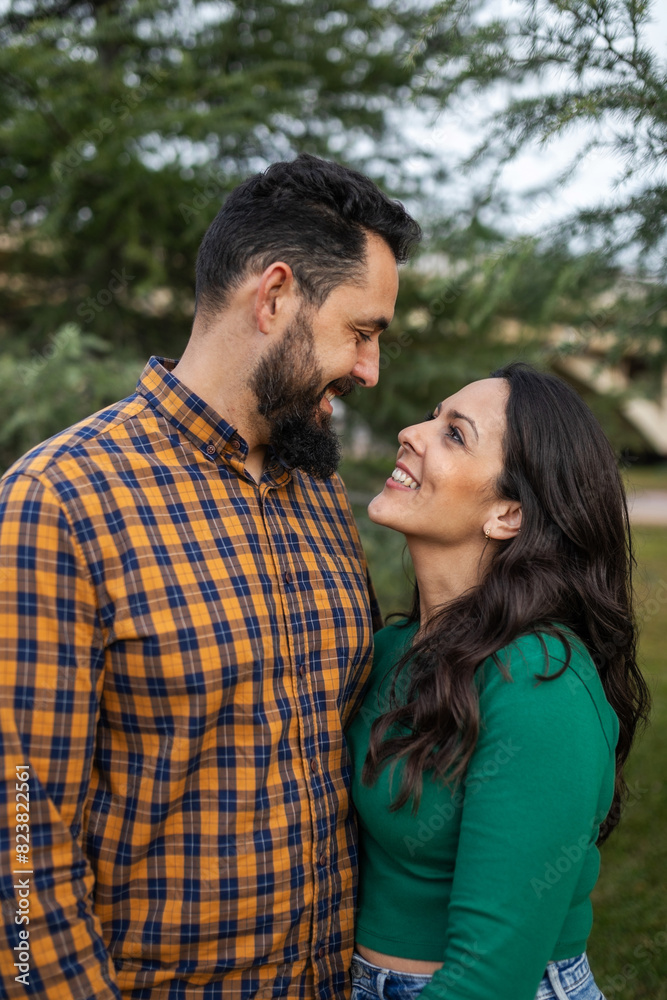 portrait of young couple hugging outdoors in nature portrait of young couple hugging outdoors in nature