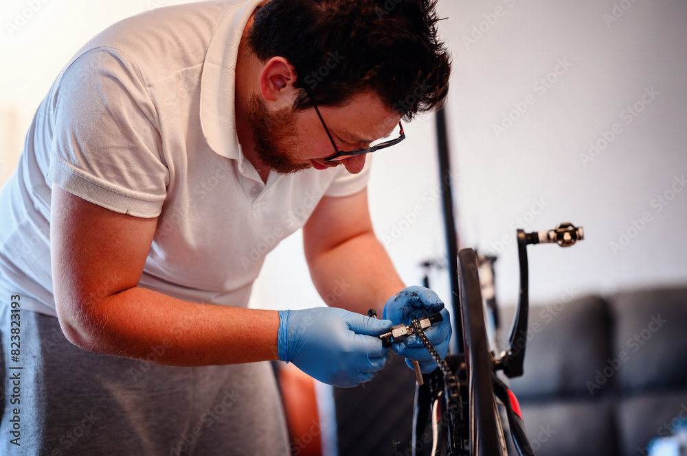 A mechanic wearing blue gloves adjusting a bicycle chain with a specialized tool, focusing on precision and technical skill. A mechanic wearing blue gloves adjusting a bicycle chain with a specialized tool, focusing on precision and technical skill.