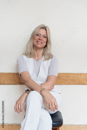 Portrait Of A Happy Mature And Stylish Woman Sitting With Long Hair. photo