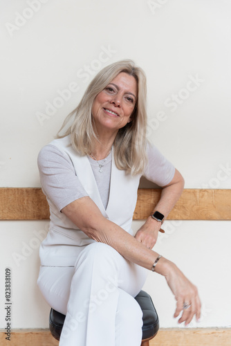 Portrait Of A Mature And Stylish Woman Sitting With Long Hair. photo