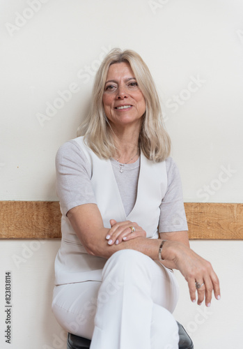 Portrait Of A Mature And Stylish Woman Sitting With Long Hair. photo