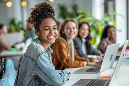 The company's employees or students are sitting and discussing the project. Young, happy, modern people of different genders and ages as members of one team.