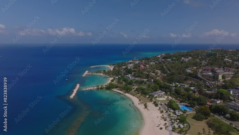 Aerial view of Jamaica's coastline, showcasing pristine beaches, clear waters, and lush greenery in the Caribbean Aerial view of Jamaica's coastline, showcasing pristine beaches, clear waters, and lush greenery in the Caribbean
