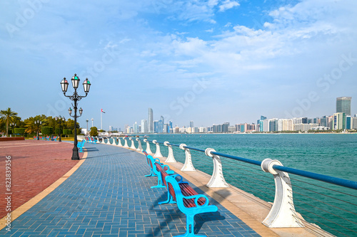 Waterfront view of Abu Dhabi with sea, skyscrapers from Corniche embankment.