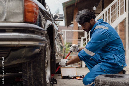 The mechanic opens the hood of the car, inspects it, repairs the car at home and provides service. Mechanic technician checking engine, car service, repair, maintenance, checking car concept