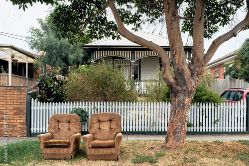 Vintage armchairs discarded on suburban street
 photo