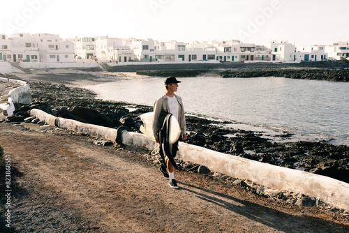 A surfer leaves Lanzarote in search of a high tide