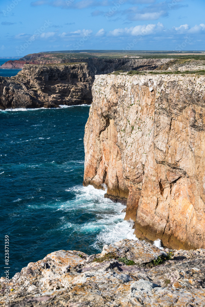 Rocky coastline in Sagres, on the Algarve coast of Portugal. Farol do Cabo de Sao Vincente Rocky coastline in Sagres, on the Algarve coast of Portugal. Farol do Cabo de Sao Vincente
