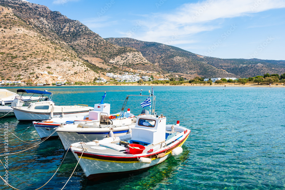 Traditional fishing boat anchoring in Kamares port, Sifnos island, Greece Traditional fishing boat anchoring in Kamares port, Sifnos island, Greece