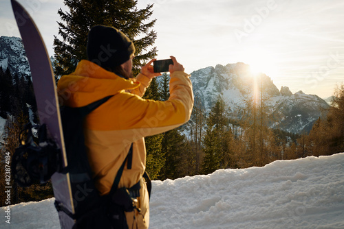 Skier photographs the mountain scenery photo