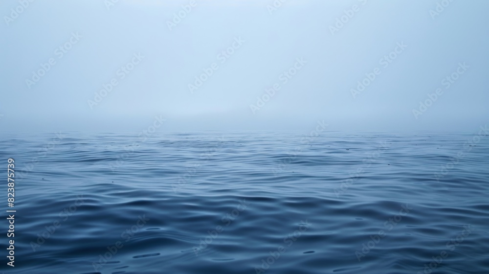 A misty ghostlike haze rises from the ocean surface making it difficult to see the horizon. A misty ghostlike haze rises from the ocean surface making it difficult to see the horizon.