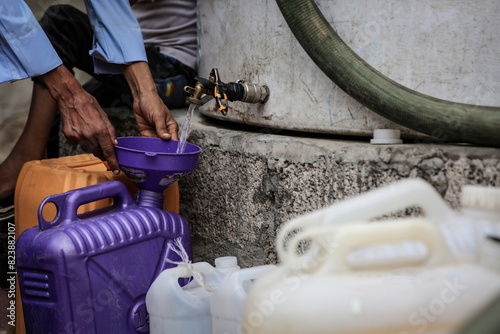 A Yemeni collects water due to the water crisis in the city of Taiz, Yemen	