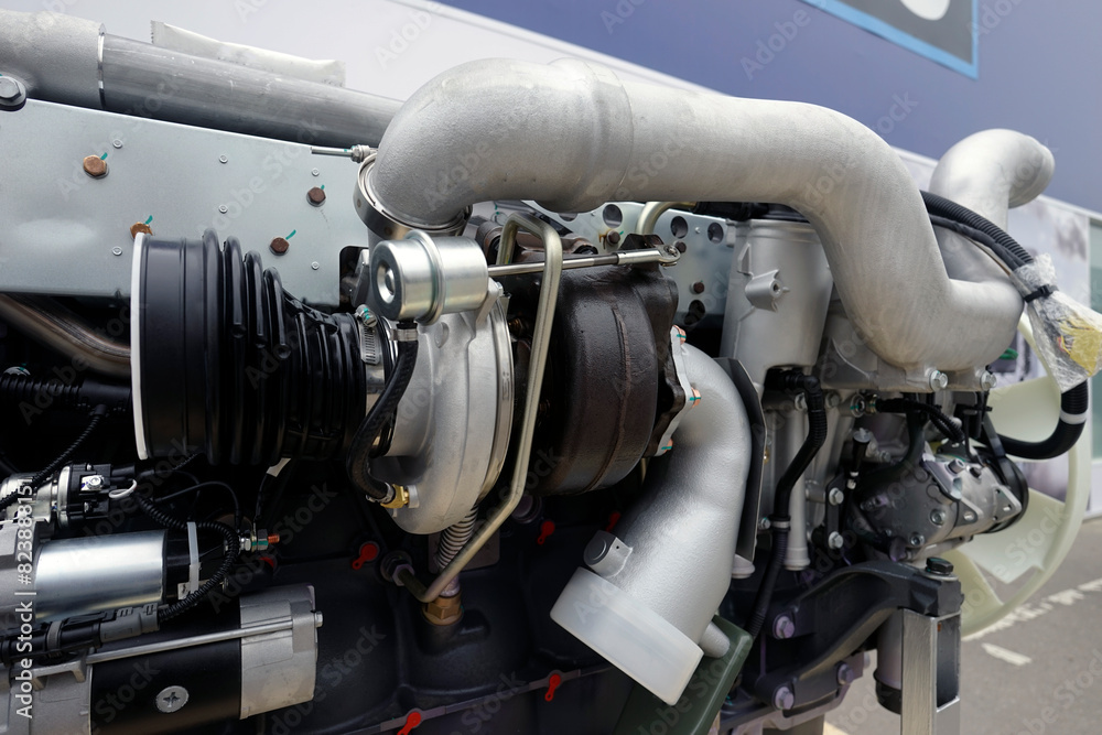 A close-up of the turbocharger installed on the engine. An engine component necessary to increase power. A close-up of the turbocharger installed on the engine. An engine component necessary to increase power.