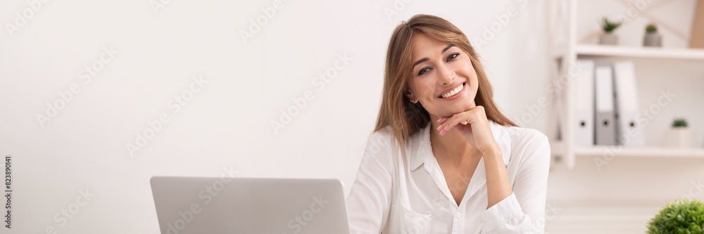 Business Career. Successful Entrepreneur Lady Sitting At Laptop Smiling At Camera In Modern Office, Copy Space Business Career. Successful Entrepreneur Lady Sitting At Laptop Smiling At Camera In Modern Office, Copy Space