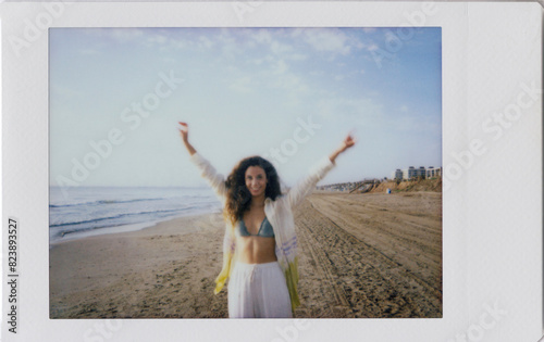 Polaroid photo scan of young happy woman at beach photo