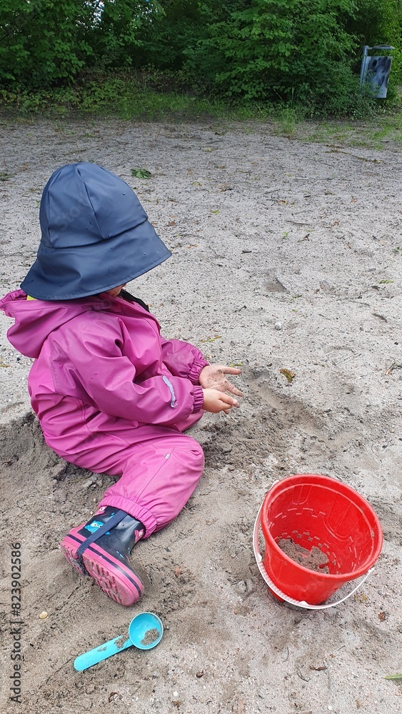 little child playing in sandbox little child playing in sandbox